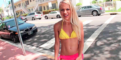 Blonde is running around in a skimpy outfit outside on the street