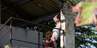 Naughty lesbians are making out and licking by the abandoned building