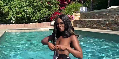 Lavish ebony doll Ana Foxxx gets naked and dives into the swimming pool