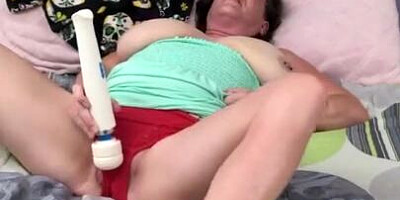 Perverted granny is rubbing her clit with a huge toy