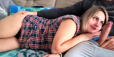 Stepsister is lying on her stepbrother's lap and he suddenly starts masturbating his dick near her mouth