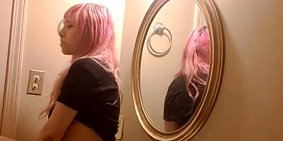 Pink-haired teen is filming herself while rubbing her twat in a bathroom