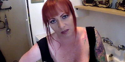 Redhead MILF flirts with the camera while sucking a hard dick