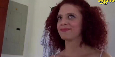 Redhead MILF is lured into a hotel room and engaged in hardcore sex