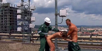 Two hard cock pleasing a slim German girl on the rooftop