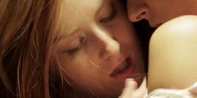 Redhead and brunette are enjoying sensual sapphic love on a sofa