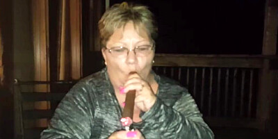 Amateur mature is smoking a cigarette in front of the camera