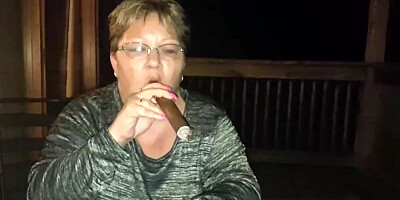 Amateur mature is smoking a cigarette in front of the camera