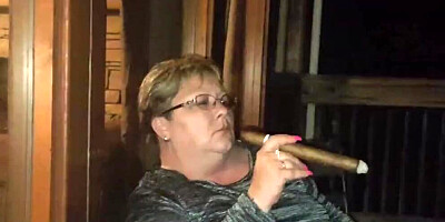 Amateur mature is smoking a cigarette in front of the camera