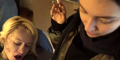 Two drunk girls are blowing a stranger at the party