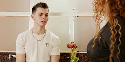 Curly-haired MILF goes down on her stepson and blows him in the kitchen