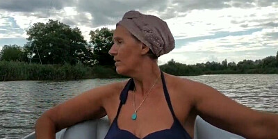 Mature lady paddles in that boat as her partner films her legs