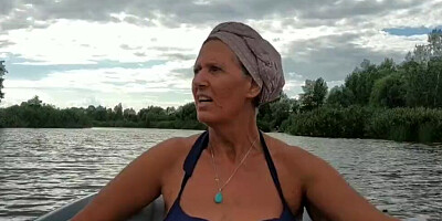 Mature lady paddles in that boat as her partner films her legs
