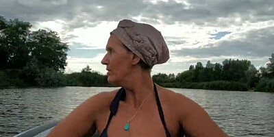 Mature lady paddles in that boat as her partner films her legs