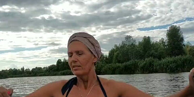Mature lady paddles in that boat as her partner films her legs