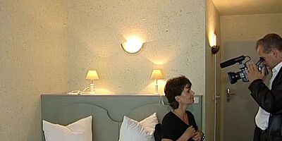 Short-haired mature woman is filmed while sucking a hard cock