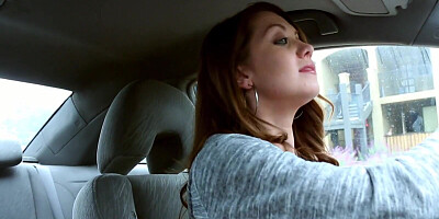 Chrissy Marie is smoking a cigar while driving a car