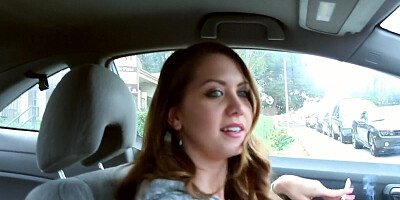 Chrissy Marie is smoking a cigar while driving a car