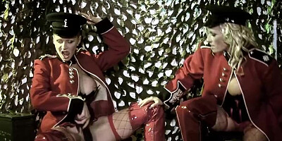 Bisexual women playing with a dildo engage in group sex with other soldiers