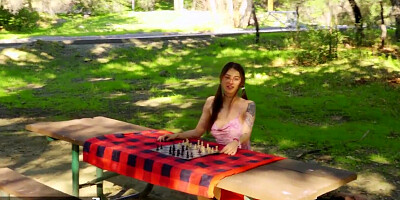 Beautiful dark haired honey wearing glasses gets fucked while plays chess outdoors