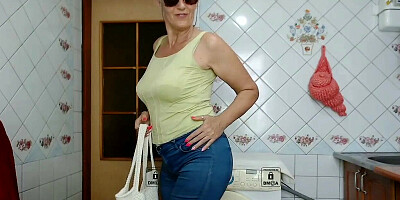 Elegant granny with big natural tits strips in front of the camera