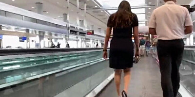 Randy guy is walking through an airport with his camera and filming big butts