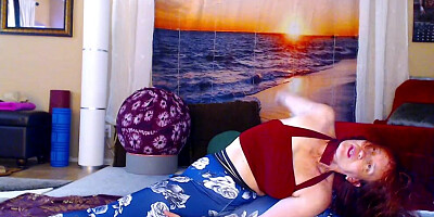 Redheaded chick is practicing some yoga in front of the cam