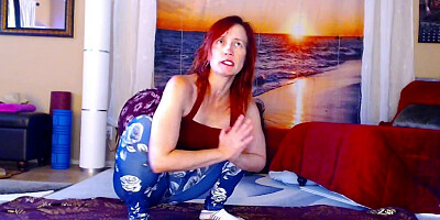 Redheaded chick is practicing some yoga in front of the cam