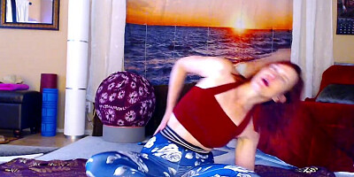 Redheaded chick is practicing some yoga in front of the cam