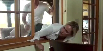 MILF is stuck in the window while two guys are fucking her