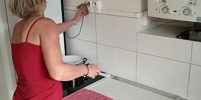 Blonde cougar is being fingered in the kitchen by a kinky stepson