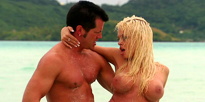 A girl with large tits is on an island with her partner, getting fucked