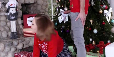 Two slutty girls are fucked by two guys by the Christmas tree