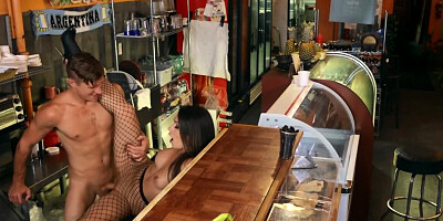 Barmaid in fishnet pantyhose offers the customer a sex cocktail