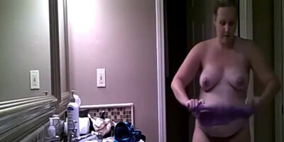 Chubby amateur MILF is being secretly filmed while getting naked
