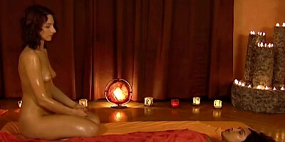 Naked masseuse is massaging Latina girl rubbing her body with oil