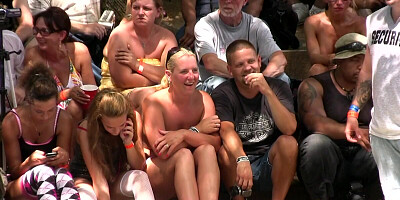 Naked girls are wrestling in front of a huge crowd