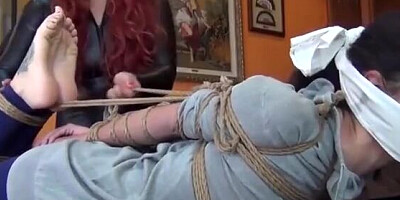 Brunette girl is tightly tied up by that perverted mistress