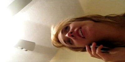 Slutty blonde talks with her boyfriend while giving a blowjob to another guy