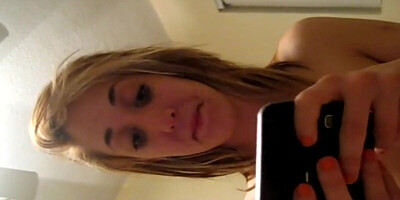 Slutty blonde talks with her boyfriend while giving a blowjob to another guy