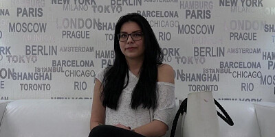 Cute young gal with glasses is interviewed on a porn casting