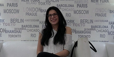Cute young gal with glasses is interviewed on a porn casting