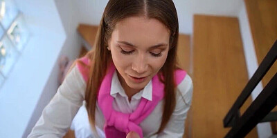 Mary Rock wears her college outfit while blowing him