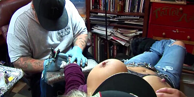 Shyla Stylez gets tattooed while playing with her tits