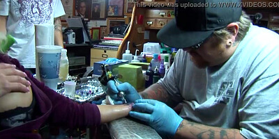 Shyla Stylez gets tattooed while playing with her tits