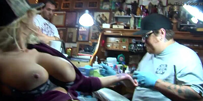 Shyla Stylez gets tattooed while playing with her tits