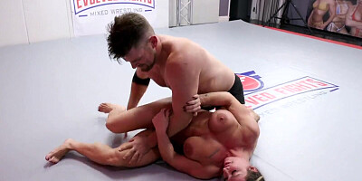 Muscled babe Brandi Mae is wrestling with a guy on the floor