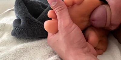 Kinky man is pushing his cock between MILF's lovely feet