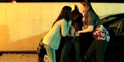 Passionate lesbian threesome between young chicks on a parking lot