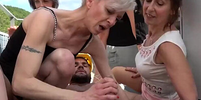 Bunch of slutty MILFs are fucked by a horny construction worker outside